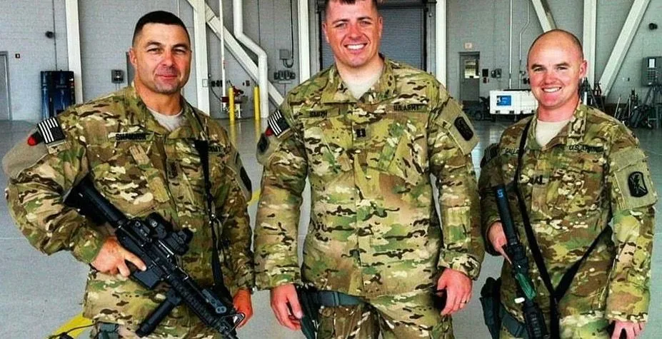 Deployed in Afghanistan with his fellow Soldiers. Mark C. Smith in U.S. Army combat uniform alongside two fellow soldiers during an Afghanistan deployment.