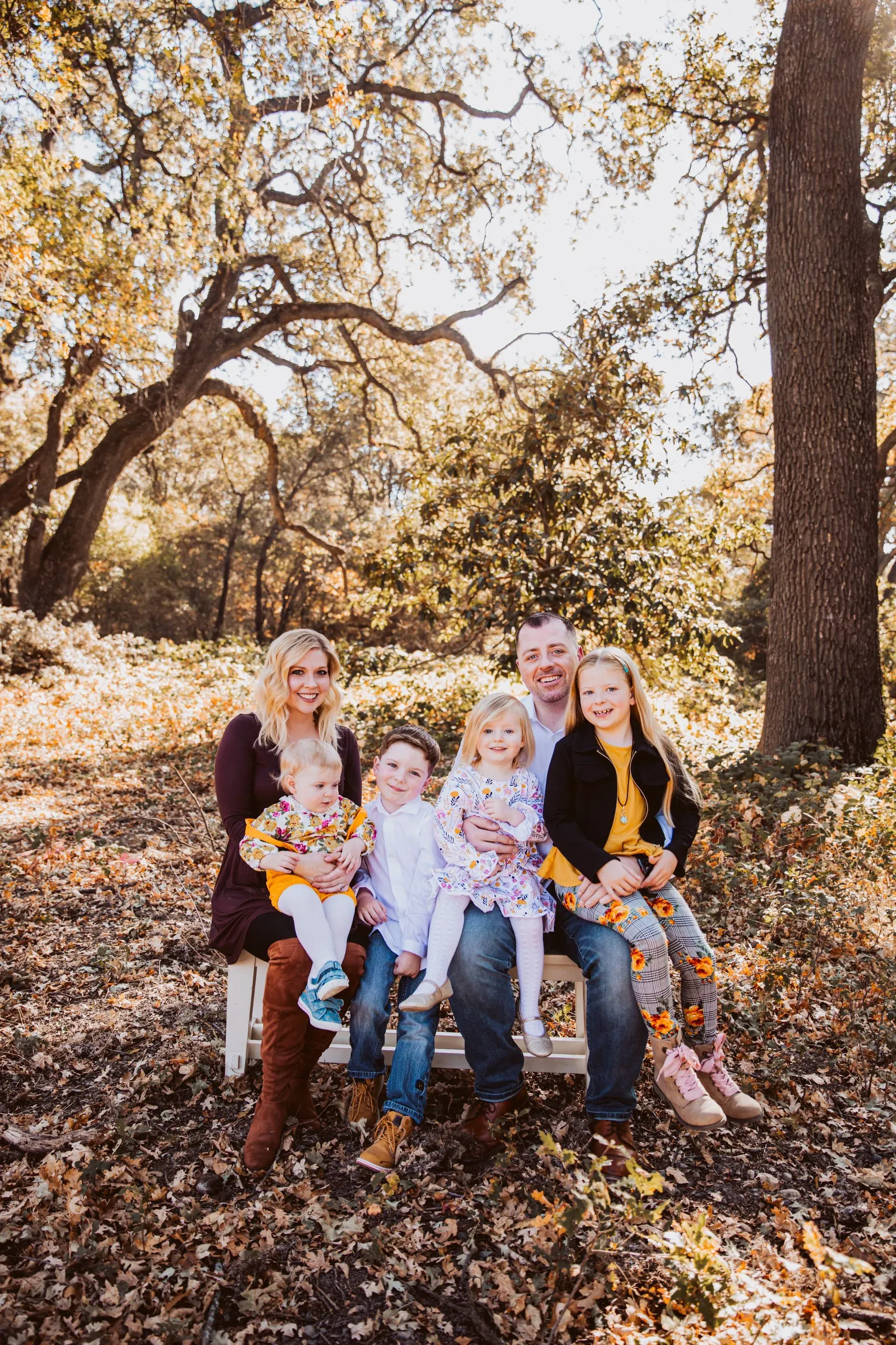 With Julie and their four children — the family Mark calls home. Mark C. Smith with his wife Julie and their four children, photographed outdoors among California oak trees.