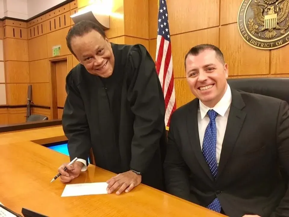 With the Hon. Morrison C. England, Jr. — federal clerkship, U.S. District Court, Eastern District of California. Mark C. Smith with the judge during his federal judicial clerkship.