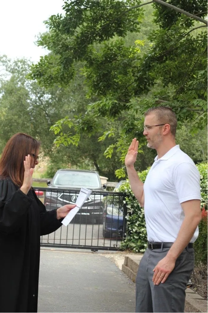 Sworn in as an attorney. Nicholas Jacobs raising his right hand before a judge in robes.