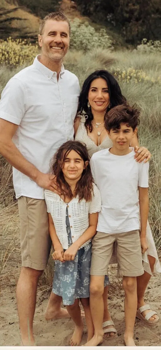 With his wife Lydia and their two children. Nicholas Jacobs and his family on a California beach.