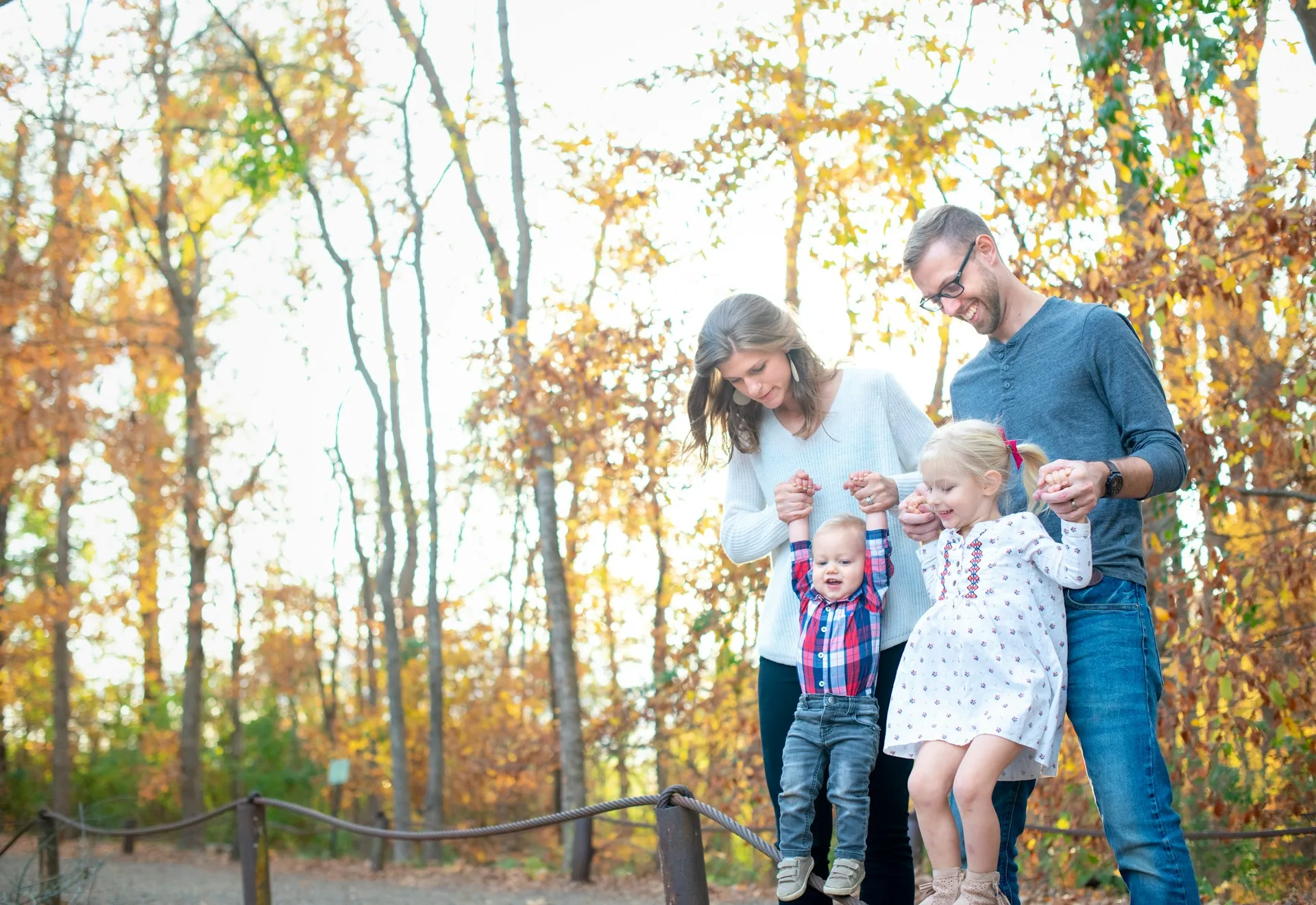 A young California family walks together along a wooded path.